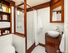 Spacious bathroom with luxurious shower and custom woodwork throughout.