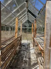 Greenhouse with concrete flooring, removeable panels, and water already available!  Custom shelving