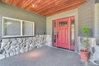 Shot of your front entry, grand in scale. I love all the stone, the huge covered area with wood on the ceiling - very PNW. Custom door with leaded glass as well. Nest doorbell stays. Welcome home!