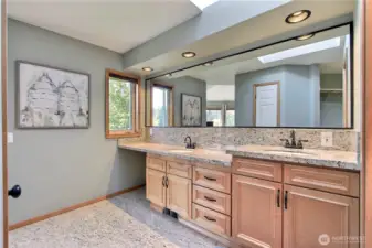 Primary ensuite bath view one, love the custom cabinetry, granite tiered double vanity with huge mirror. Quality tile flooring and skylights are really nice as well.