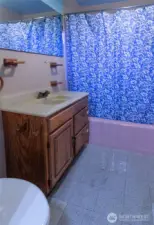 The bathroom has a shower/tub combination!