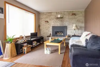 The living room in the guest house has a fireplace to warm you up when the seasons change to fall and winter!