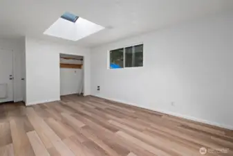 Family room with skylight and door to backyard.
