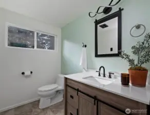 Primary bathroom with tile floor.