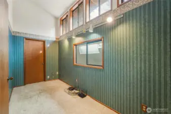 This room upstairs with all its windows allows for a office if you desire.  The back door leads to a huge unfinished room with tons of possibilities.