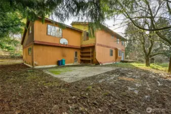 Garage door leads to a play area in the back yard.