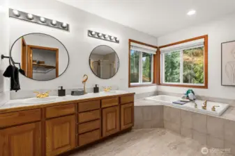 Primary bedroom ensuite full bathroom with updated fixtures, hardware, and mirrors.