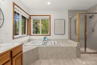 Primary bedroom ensuite full bathroom with updated fixtures, hardware, and mirrors.