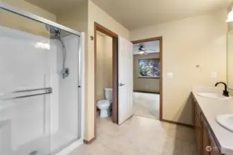 Walk-in shower with glass door completes the 5-piece bathroom with separate potty room.