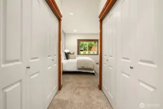 Primary double closets between bedroom and attached bathroom.