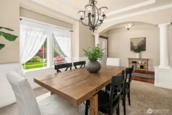 Notice column details and loads of light in the formal dining room.