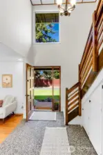 Bright entry way window brings in tons of sunlight!  Sturdy custom wood railing for stairs is built to last a lifetime!