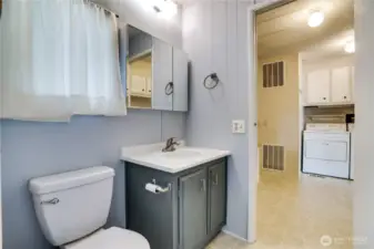 The second bathroom offers a vanity, large medicine cabinet and access to the laundry/office space.