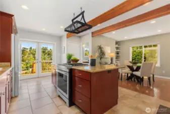 Enormous kitchen with granite tile counters, custom cherry cabinets, and matching stainless appliances