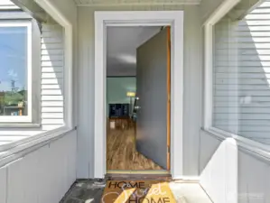 The darling covered entryway allows you a spot to remove your shoes before coming in.