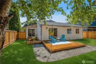 Backyard with two wood decks (grass digitally enhanced)