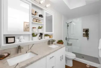 Large walking shower and double sinks are featured in the primary bath.