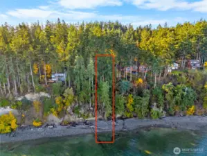View from the water side ( there are 2 parcels included in this listing) highlighting about 60 feet of owned waterfront with tidelands and a naturally wooded high-bank setting.