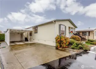 Carport parking and additional driveway parking. Storage shed attached to carport.