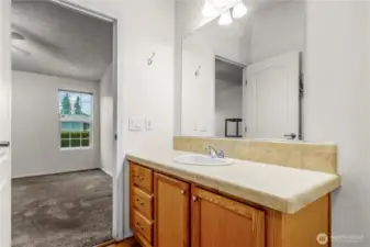 Another view of primary bathroom vanity back toward the bedroom.