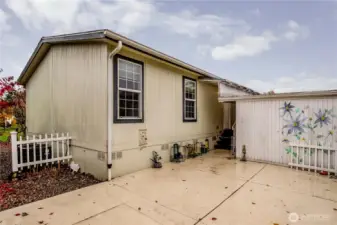 A low-maintenance, private patio area can be found behind the carport. Great for potted plants and enjoying the outdoors.