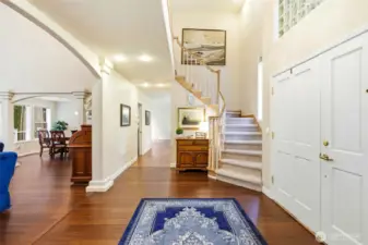 Spacious two-story entry with open staircase, natural light, and seamless flow into main living areas—perfect for entertaining in this 3,490 sq ft Lake Wilderness home.