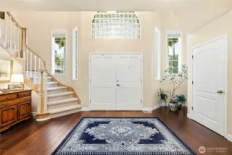 Bright and open foyer with vaulted ceilings, bamboo floors, and architectural detailing, setting the tone for this elegant Maple Valley lake view property.