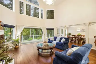 Main spacious living area with vaulted ceilings, large windows, and fireplace—ideal for multi-generational living or flexible family space.