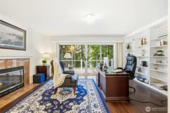 Cozy family room with fireplace, built-ins, and sliding doors leading to the expansive deck—blending comfort and Northwest lifestyle.