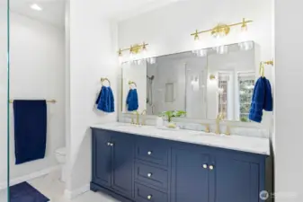 Elegant dual vanity with updated cabinetry, modern lighting, and generous counter space in the remodeled primary bath of this Maple Valley luxury home.
