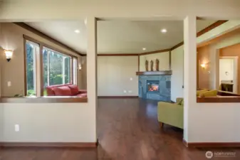 View from breakfast nook into living room with gas fireplace
