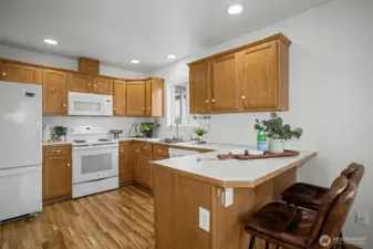 Kitchen featuring ample cabinetry and perfect breakfast bar.