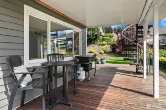 The outdoor spaces include this West-facing covered deck area with lake views, perfect for year-around barbeques and outdoor dining.  The Ironwood deck wraps around the Southwest corner of the home to the back yard.
