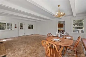 Windows on every wall invite varying views. The kitchen is straight ahead.