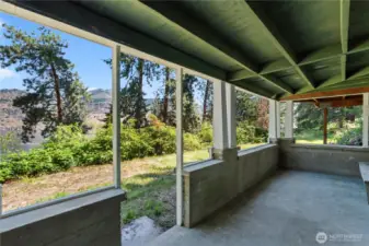 This covered patio, located just outside the lower level bedroom, nicely frames the views.