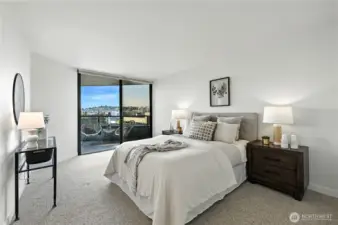 Wonderful king size primary suite leads to breathtaking Space Needle views off the covered deck!