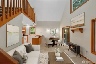 Natural light filters through the trees, dancing across warm wood finishes and the inviting glow of the propane fireplace—the perfect spot to curl up on chilly evenings with a blanket and a favorite book.