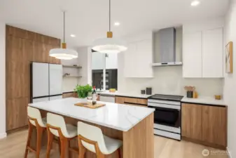 A statement island anchors the room, offering the perfect perch for morning coffee or evening conversations.