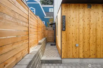 A cedar-lined walkway leads to your private entry—modern craftsmanship in every board and brick.