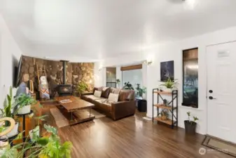 The living room features a large bay window overlooking the front yard.