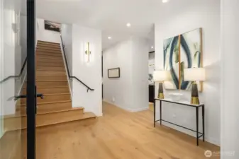 The welcoming entry showcases the gleaming oak plank floors.