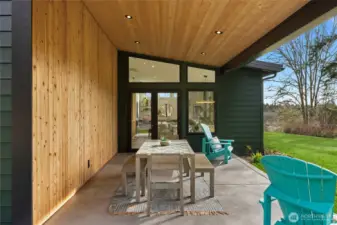 The patio is framed by a pine wall and ceiling.