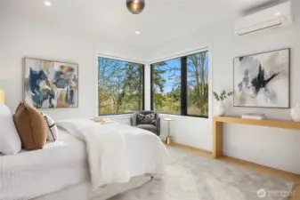 On the east side of the home, the main floor primary bedroom has a tranquil territorial view.