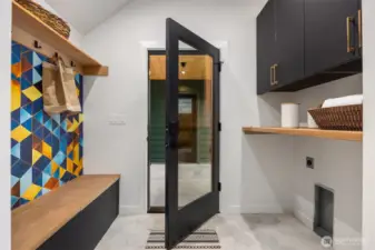 Mudroom/laundry room are on the main floor and feature a built-in bench with shoe storage.
