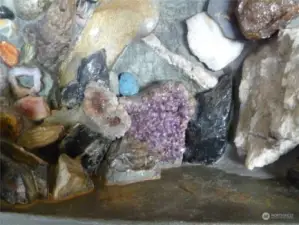 Some of the hundreds of imbedded treasures in the fireplace wall / mantle.