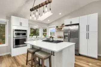 Updated kitchen with quarts countertops, large pantry with pull-out organizers and gas cooktop with downdraft range hood.