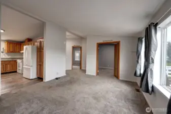 Living room looking into the kitchen, bedroom #2 and study/office/extra sleeping room
