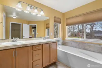 Double sinks, soaking tub, and natural light pouring in