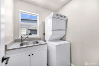 Utility room with sink and room for additional storage conveniently located on the second level with bedrooms