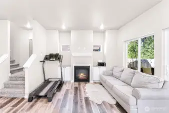 Main living area has an abundance of light with built in cabinets on each side of the cozy gas fireplace